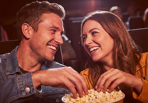 Couple sharing popcorn at AMC Burbank 16